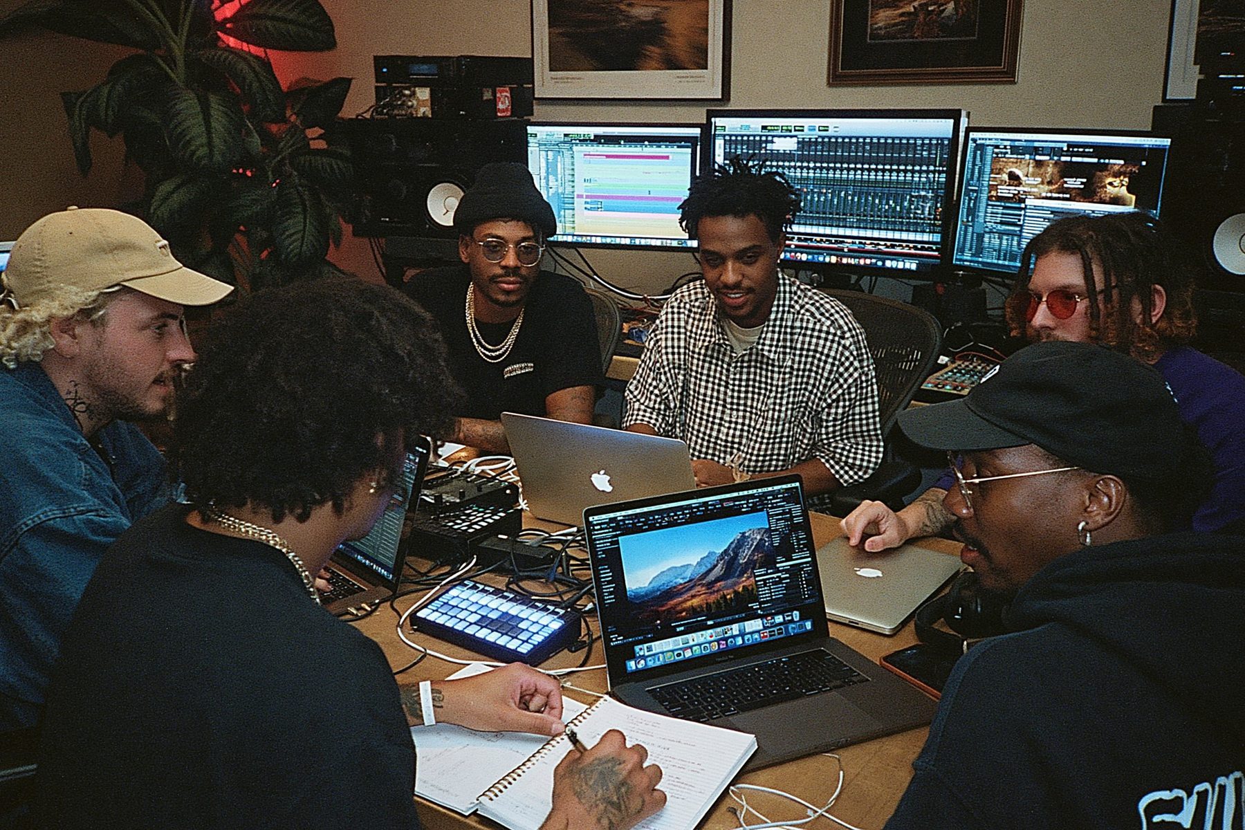 Producers at a studio desk lined with monitors during an MPC Accelerator session